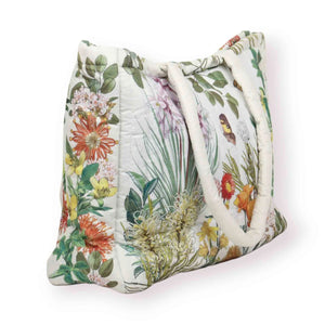 Floral patterned bag with white handles on a white background