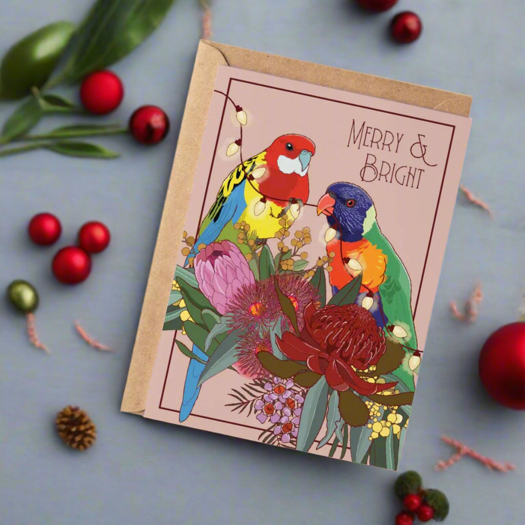 Greeting card with colorful parrot illustration and 'Merry & Bright' text on a white background
