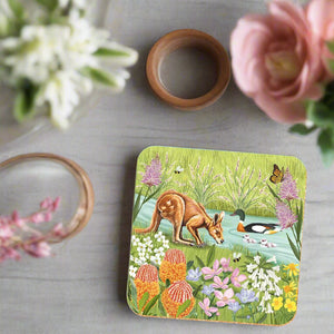 Decorative coaster with a nature-themed design featuring animals and plants on a white background.