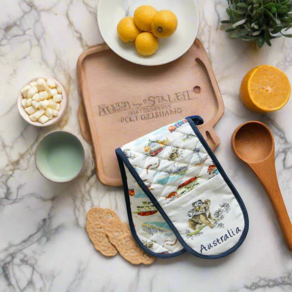 Pair of oven mitts with Australian-themed design featuring a koala and landscapes.
